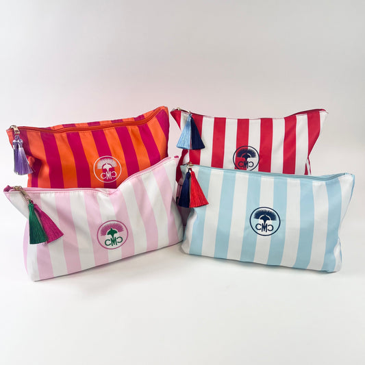 Four striped tile bags in various striped colors with tassels on a white background.