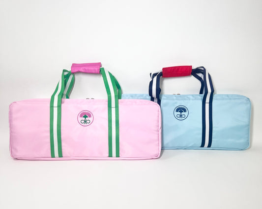 Two colorful rack bags with striped designs on a white background