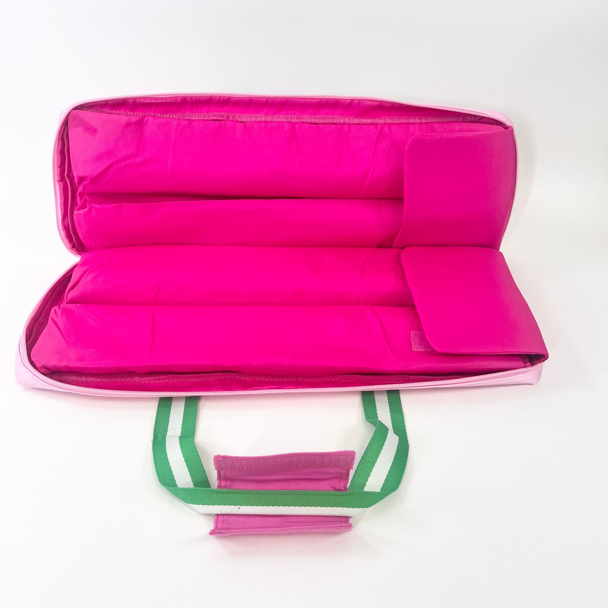 Hot Pink interior of rack bag with green handles on a white background