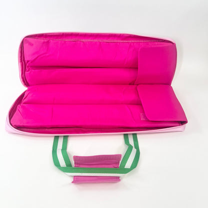 Hot Pink interior of rack bag with green handles on a white background